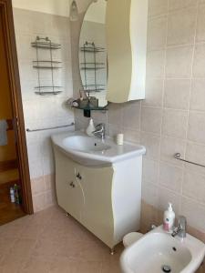 a bathroom with a sink and a mirror at Le petit coin de Lea in Quart