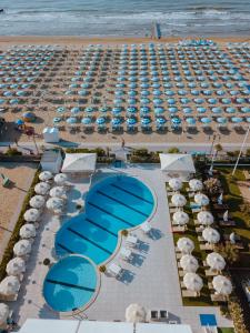 an aerial view of a beach with umbrellas and the ocean at Hotel Galassia Suites & Spa in Lido di Jesolo