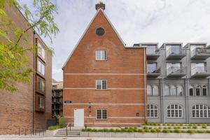 an external view of a brick building with a tower at Charming Loft City Center in Copenhagen