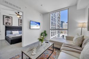 a living room with a couch and a large window at Amazing Unit in Downtown Miami With Free Parking in Miami