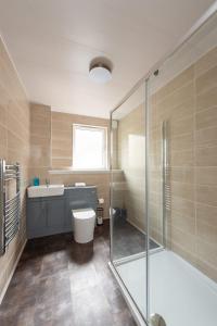 uma casa de banho com um WC, um lavatório e um chuveiro em Ground Floor 2 Bed Flat Slateford em Edinburgo
