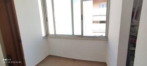 an empty room with a window and a floor at Da Serraona appartamento ad Alghero in Alghero +3 photos