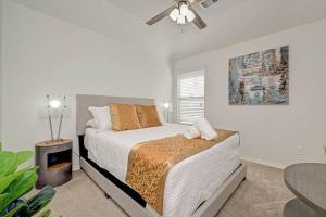 a white bedroom with a bed and a table at IAH-Houston Hideaway - Free Parking, WiFi, Sleeps 10 in Humble
