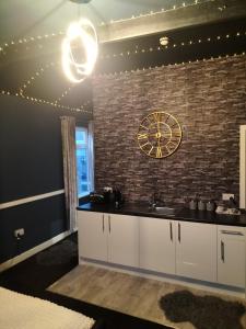 a kitchen with a clock on a brick wall at THE NEW INN Newton Derbyshire in Tibshelf