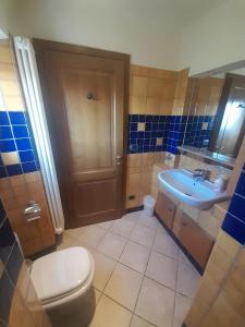 a bathroom with a toilet and a sink at Olive Tree Suites Farmstay Villa in Lamporecchio