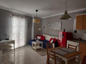 a living room with a blue couch and a table at Apartamento Iceberg in Tazacorte
