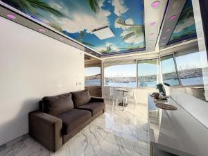 a living room with a couch and a table at 240 Magnifique Appart Deluxe Hammam vue mer in Cap d'Agde