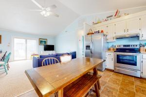 a kitchen with a wooden table in a room at Cap'n Stilts in Hatteras