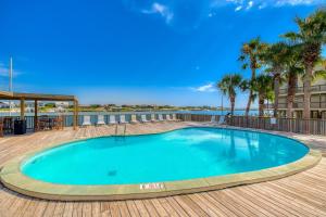 a swimming pool on a deck with palm trees at Lei Lani Village 103 in Orange Beach