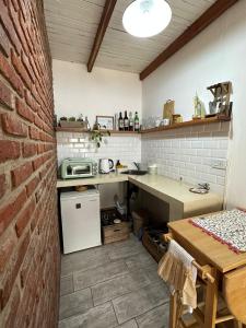 a small kitchen with a brick wall and a table at Loft en Las Flores in Las Flores