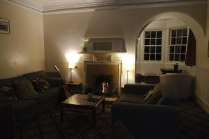 a living room with a couch and a fireplace at Glencoe Outdoor Centre Hostel in Glencoe