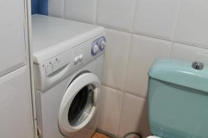 a bathroom with a washing machine and a toilet at La Carbonera in Alaejos