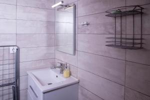 a white bathroom with a sink and a mirror at Dimitra's Country House in Forest and Sea (2) in Metamorfosi