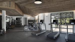 a gym with several treadmills and elliptical machines at Four Seasons Resort Napa Valley in Calistoga