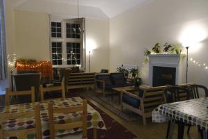 a living room filled with furniture and a fireplace at Glencoe Outdoor Centre Hostel in Glencoe