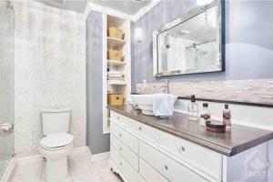 a bathroom with a white toilet and a sink at Fully furnished Townhome with Driveway Near DT in Ottawa