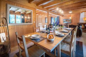 a dining room with a long wooden table and chairs at Chalet Igel - OVO Network in Châtel