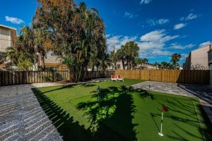 a yard with a miniature golf course with a tree at Beautiful Beach Home in Clearwater Beach