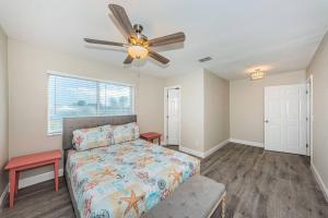 a bedroom with a bed and a ceiling fan at Beautiful Beach Home in Clearwater Beach