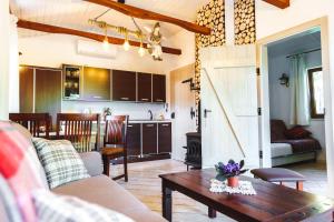 a living room with a couch and a table and a kitchen at Swornegacie Domek Mati 1 in Swornegacie