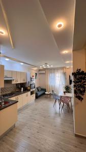 cocina grande con armarios blancos, mesa y sillas en GOLF LOFT( BLUE S 78 ), en Argel