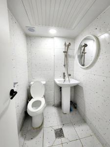 uma casa de banho branca com um WC e um lavatório em Friends Yul For men em Seul