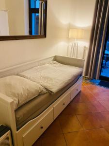a bed sitting in a room with a mirror at Apartment mit Terrasse iP-TV Stellplatz in Krefeld
