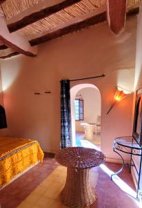 a living room with a table and a couch at Auberge Famille Benmoro in Skoura