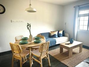 a living room with a table and a couch at La Casita de Daise in Garachico