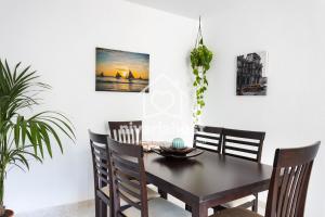 a dining room with a table and chairs at The Sea View Candelaria, by Nivariahost in Candelaria