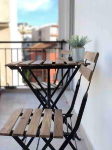 a wooden table with a potted plant on a balcony at Boutique Apartment in the Center of Ioannina in Ioannina