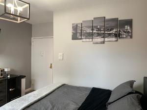a bedroom with a bed and some pictures on the wall at Brooklyn Studios By The Beach in Brooklyn