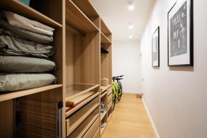 a walk in closet with wooden drawers and pillows at Tina's Riga apartments in Rīga