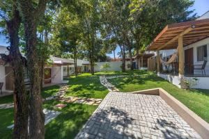 an image of a yard with a house at Charm Bahia Suites in Arraial d'Ajuda