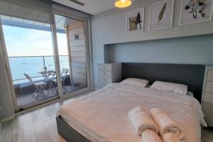 a bedroom with a bed with a view of the ocean at Ottomare Apartments in Istanbul