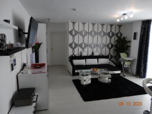 a living room with a couch and a table at FLH - Apt Sofia in Şelimbăr