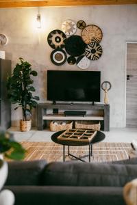 a living room with a flat screen tv and a couch at Leopard's Khaya, Marloth Park in Marloth Park