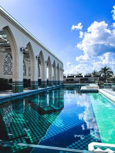 a swimming pool in a building with blue at Layla Tulum - Adults Only in Tulum