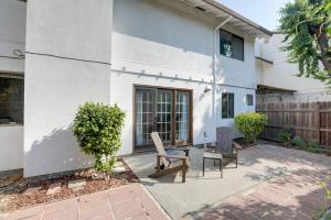 a patio with two chairs and a table in front of a house at Modern Sacramento Townhome with Patio! in Sacramento