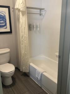 a bathroom with a tub and a toilet and a shower at Homewood Suites by Hilton Saint Louis-Chesterfield in Chesterfield
