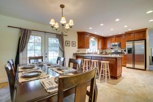 a dining room and kitchen with a table and chairs at Charming Anchorage Home with Private Hot Tub! in Anchorage