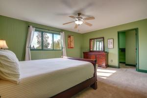 a bedroom with a bed and a ceiling fan at Charming Anchorage Home with Private Hot Tub! in Anchorage