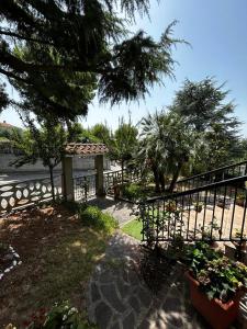 a garden with a fence and some plants and trees at B&B la casa di Polly in Falconara Marittima