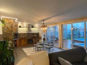 a living room with a couch and a table with chairs at Casa do Outeiro in Arcos de Valdevez