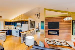 a kitchen and living room with a couch and a fireplace at The Island Treehouse in Eastsound