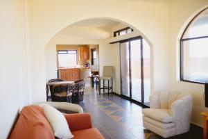 a living room with an open archway and a kitchen at Cerritos Beach Palace Casa Gaia in El Pescadero