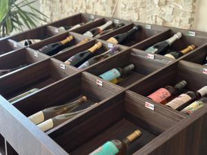 a wooden box filled with different types of wine bottles at Atrium Confort Hotels in Parauapebas