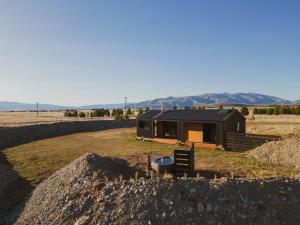 a cabin in the middle of a field at The Rise, Ben Ohau in Twizel