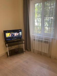 a living room with a television and a window at Natalies apartment in Yerevan