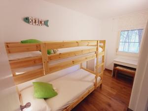 a bedroom with two bunk beds with green pillows at Apartamento con piscina y wifi cerca de la playa in Pals +16 photos